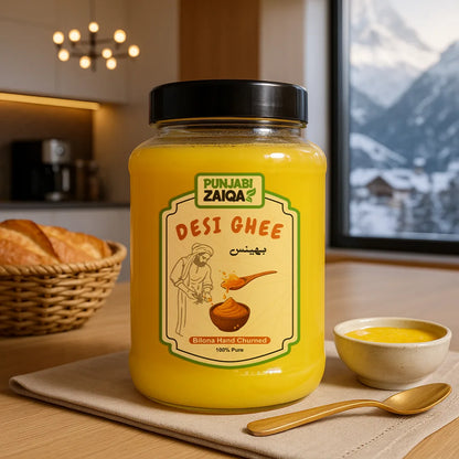 Jar of Punjabi Zaiqa buffalo Desi Ghee on a table with a bowl and spoon in a kitchen setting.